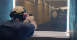 A man fires at a target in a gun range